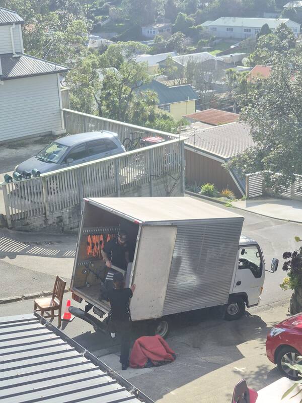 Movers loading furniture into the truck