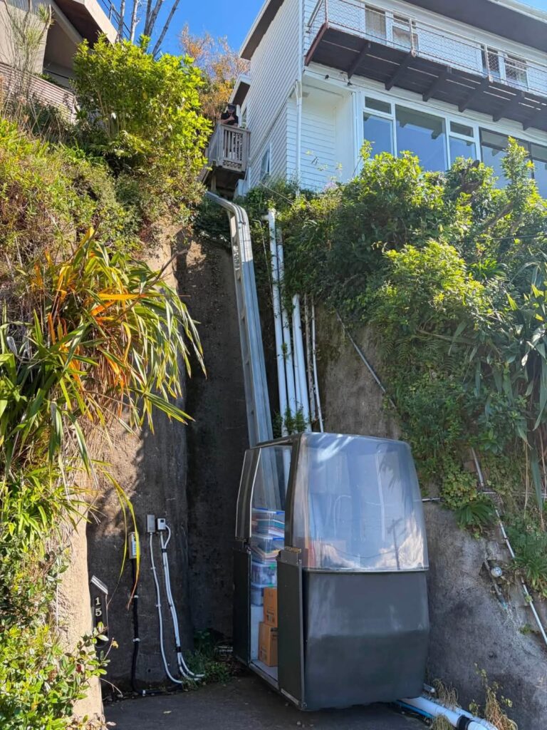 Boxes loaded into a private cable car to reach a steep hillside house