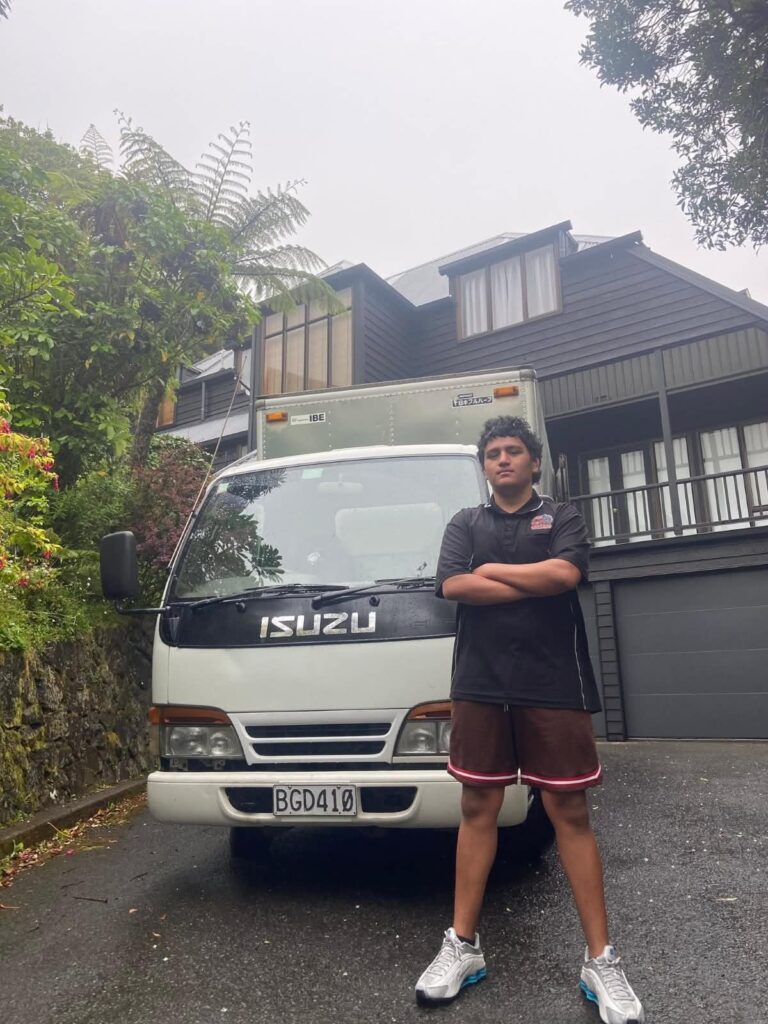 Central Relocations mover with the truck outside a Wellington home